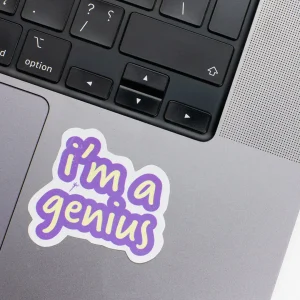 Vinyl Laptop Sticker irregular english text im a Genius shape with purple 3mm outline round corner and yellow text on macbook beside keyboard