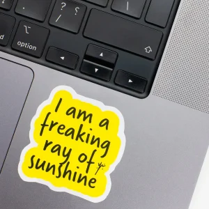 Vinyl Laptop Sticker irregular english text i am a freaking ray of Sunshine shape with white 3mm outline round corner and black yellow text on macbook beside keyboard