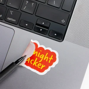 Vinyl Laptop Sticker irregular english text Midnight snacker shape with white 3mm outline round corner and yellow orange text on macbook beside keyboard