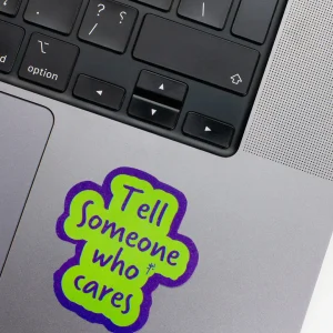 Vinyl Laptop Sticker irregular english text tell Someone who cares shape with blue 3mm outline round corner and green text on macbook beside keyboard