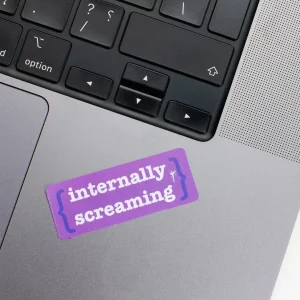 Vinyl Laptop Sticker rectangle english text Internally screaming shape with purple 3mm outline round corner and white text on macbook beside keyboard