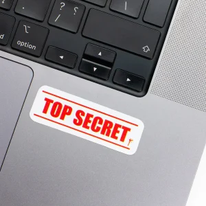 Vinyl Laptop Sticker rectangle english text Top seceret shape with white 3mm outline round corner and red text on macbook beside keyboard