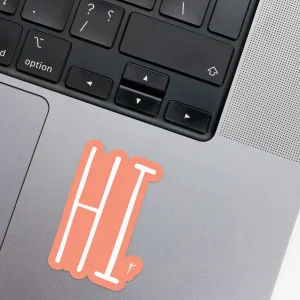 Vinyl Laptop Sticker irregular english text hi shape with simon 3mm outline round corner and white text on macbook beside keyboard