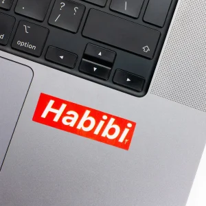 Vinyl Laptop Sticker rectangle english text habibi shape with red 3mm outline round corner and white text on macbook beside keyboard
