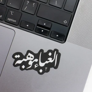Vinyl Laptop Sticker irregular arabic text ghabaa mawheba shape with black 3mm outline round corner and white text on macbook beside keyboard