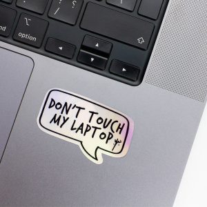 Holographic Laptop Sticker rectangle shape with round corner with black text dont touch my laptop on macbook beside keyboard with inner fill shiny metallic rainbow effect