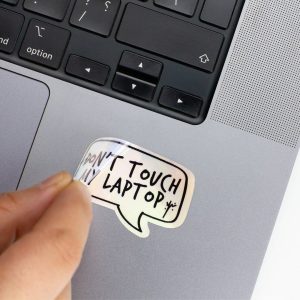 Holographic Laptop Sticker rectangle shape with round corner with black text dont touch my laptop on macbook beside keyboard peeled off slightly